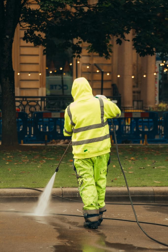 An Image of a person jet washing a floor