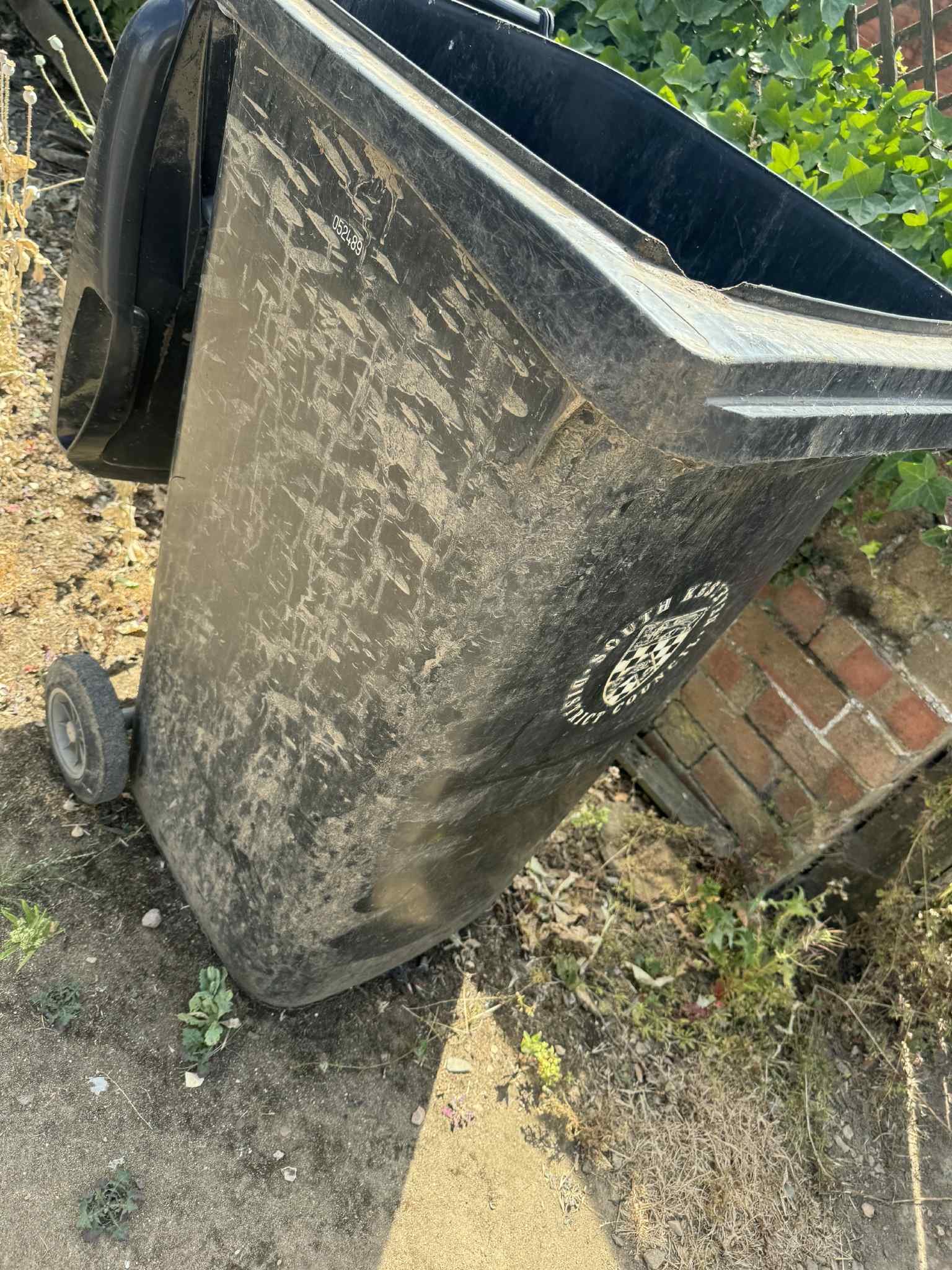 An image of a dirty black bin
